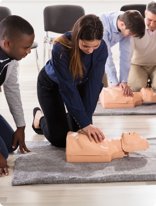 Girl using cpr on training dummy