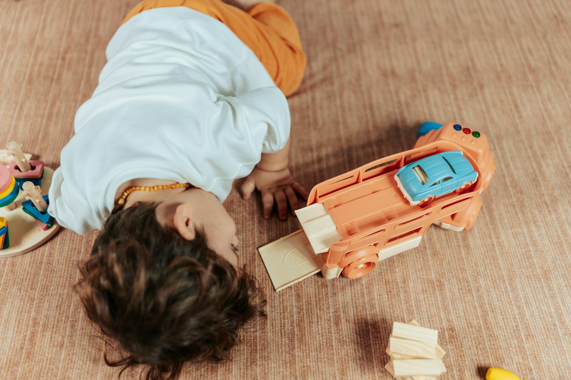 Child playing with small truck