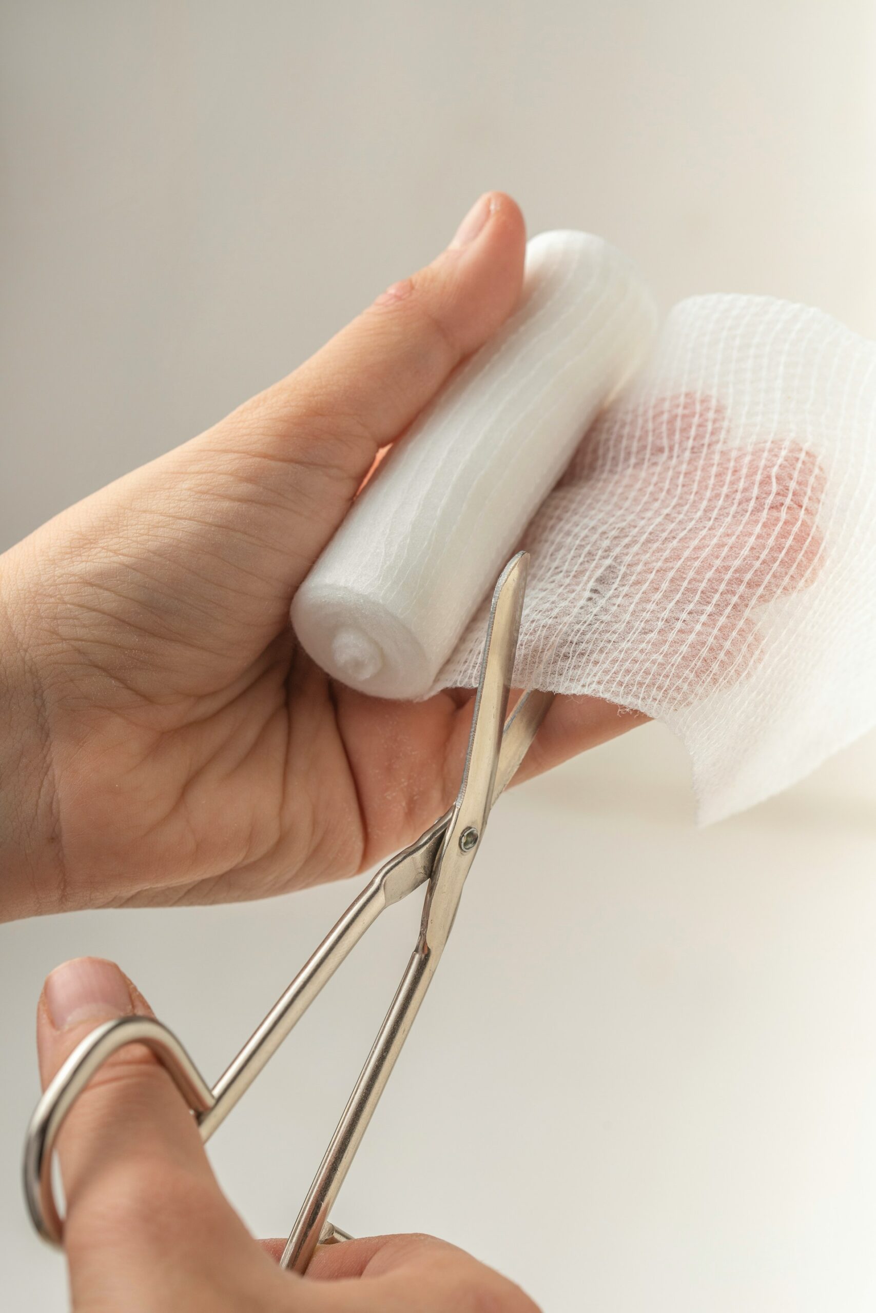 First aid bandages being cut with scissors